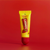 Carmex lip balm tube on a red background