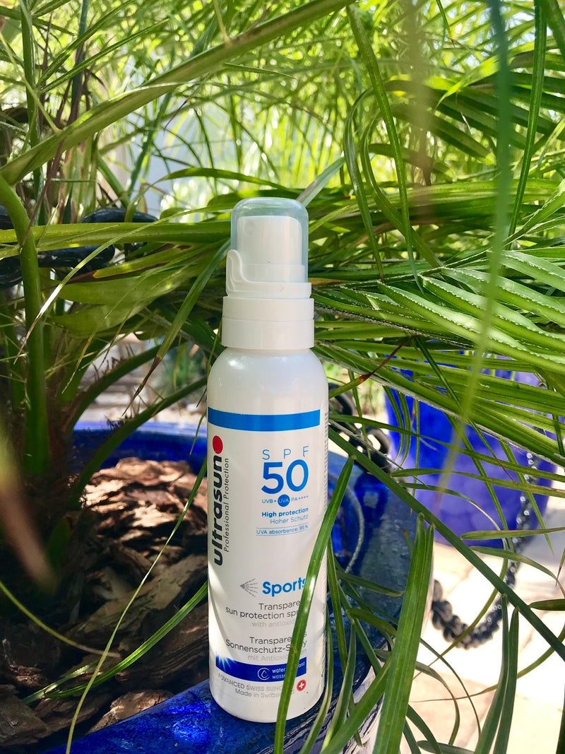 Ultrasun Clear spray SPF50 Sports Formula 150ml under palm trees lifestyle 50SPF hero