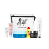 Collection of skincare products and a 'Bon Voyage!' Discovery Box on a white background