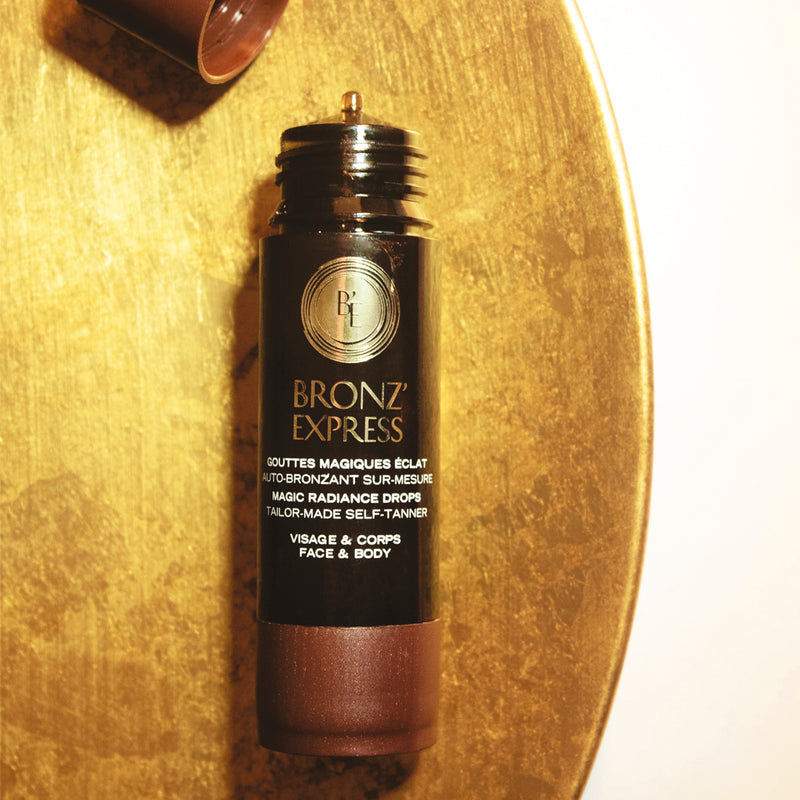 Bronz'Express Self-Tanning Drops for Face & Body 30ml opened close up lifestyle shot