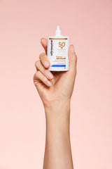 Ultrasun SPF50+ Tinted Face Fluid 40ml hand holding 